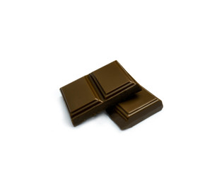 black chocolate pieces isolated on a white background. Chocolate candy