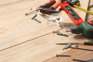 Set of tools for furniture assembling on wooden background