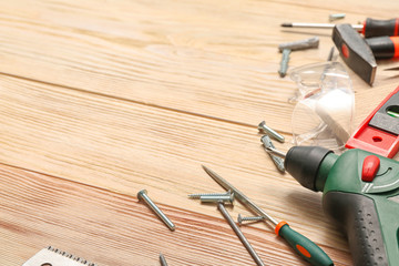 Set of tools for furniture assembling on wooden background