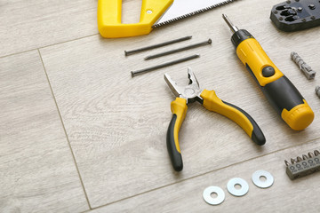 Set of tools for furniture assembling on wooden background