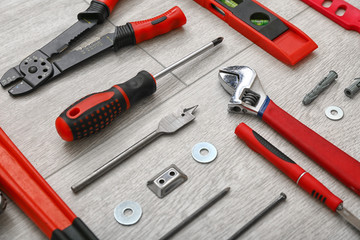 Set of tools for furniture assembling on wooden background