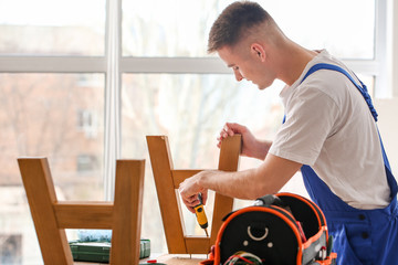 Handyman assembling furniture in workshop