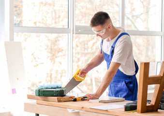 Handyman assembling furniture in workshop