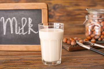 Glass of hazelnut milk on table
