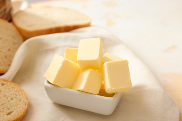 Bowl with fresh butter on table