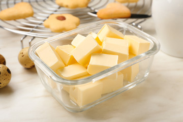 Bowl with fresh butter on table