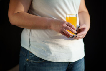 food calorific value, sugar contain, imbalanced nutrition. woman drinking orange soda, close up
