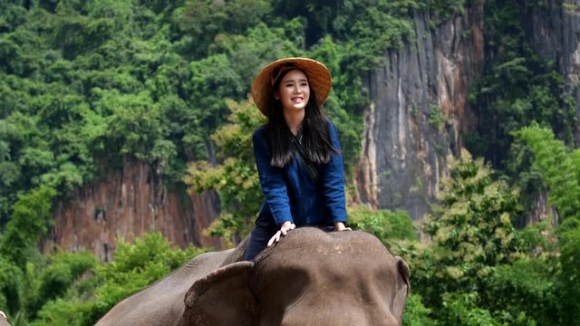 The Young Lady Riding An Elephant In The Forest 