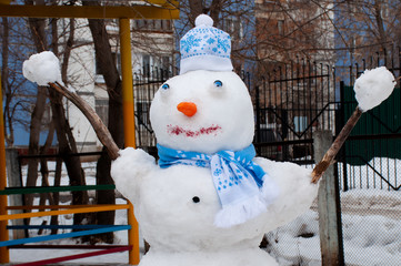 snowman in winter in a scarf