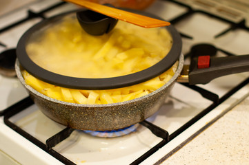 stone skillet with lid and wooden spoon