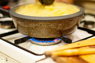 stone skillet with lid on a gas stove