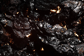 Black charcoal texture, red-hot natural mineral resource background