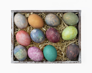 Easter eggs in a box on white background
