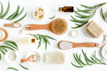 Spa Background. Natural/Organic spa cosmetics products, eco friendly bathroom accessories, eucalyptus leaves. Skincare concept on white background. Flat lay, top view