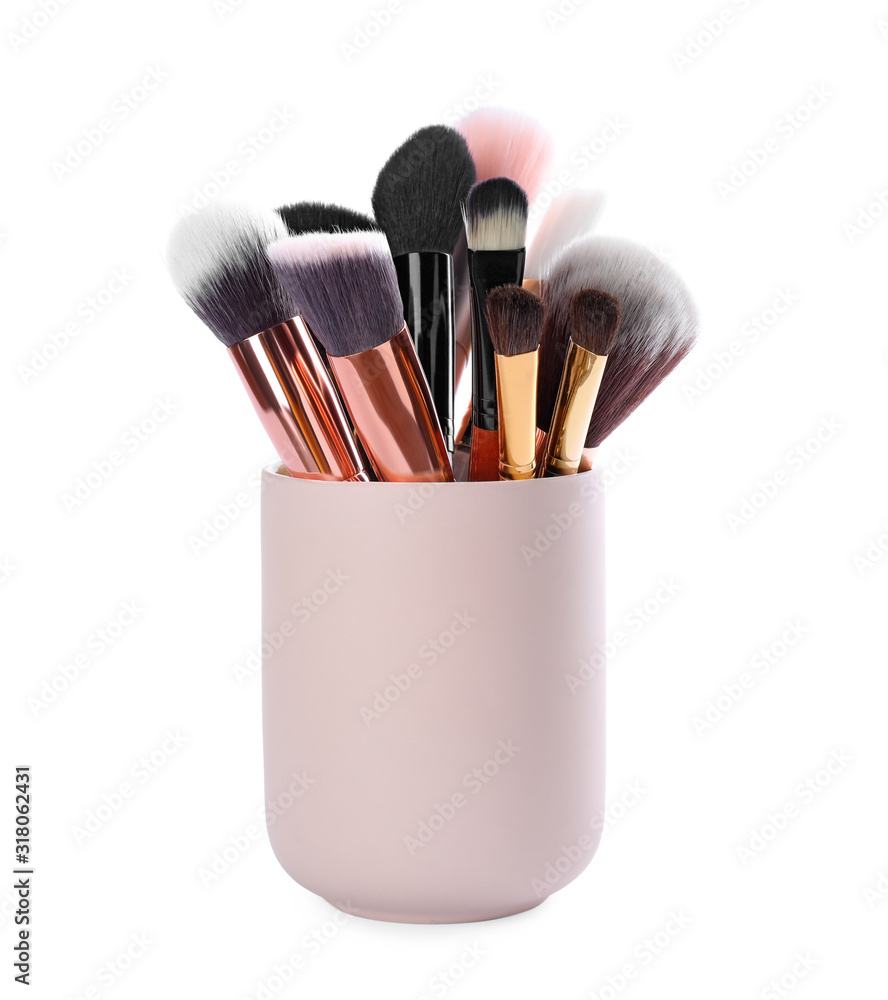 Wall mural set of professional makeup brushes in holder isolated on white