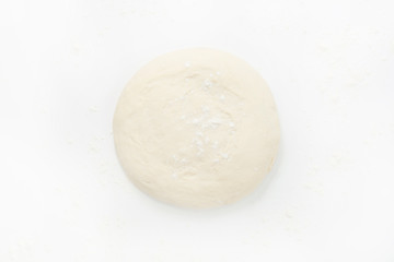 Fototapeta na wymiar Sprinkle the dough with flour, on a white background the dough is located in the middle, close-up. The concept of cooking baking.