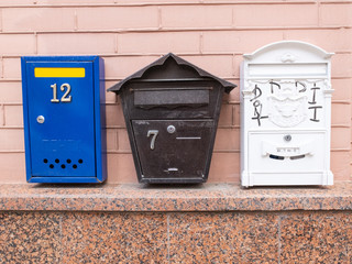 Beautiful mailboxes on a beige brick wall