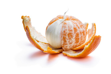 Concept of artificial fruit. Peeled mandarin with clove of garlic.