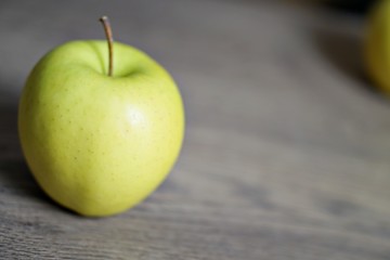 Red and green fresh apple fruit on the wood table.