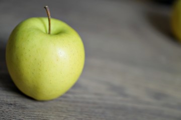 Red and green fresh apple fruit on the wood table.