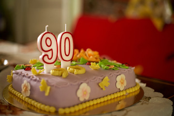 90th birthday cake with numbered candles.