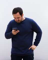 young handsome man pensive looking his mobile phone