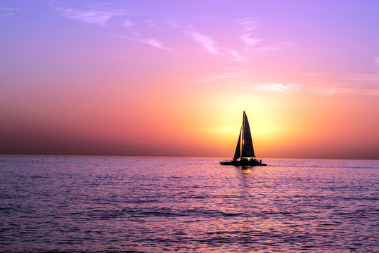 A Sailboat In Front of a Sunset