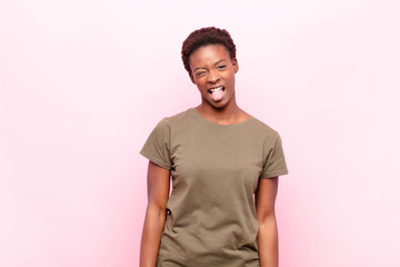 young pretty black womanwith cheerful, carefree, rebellious attitude, joking and sticking tongue...