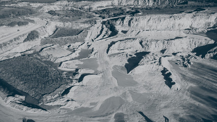 Aerial drone view of a gritstone quarry, open pit mine, mining industry, Photo taken with Mavic Mini, converted to black and white