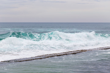 Ocean coast, moviment waves with foam.