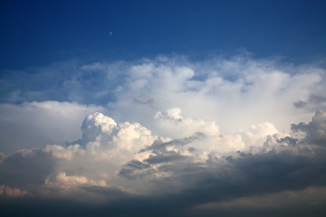 Fototapeta na wymiar storm clouds on deep blue sky