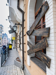 Beautiful Europe City street with cafe with boarded up window