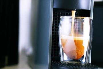 Coffee time in office. Capsule espresso in double glass cup - 100% arabica