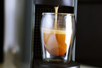 Coffee time in office. Capsule espresso in double glass cup - 100% arabica