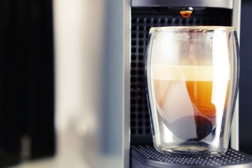 Coffee time in office. Capsule espresso in double glass cup - 100% arabica
