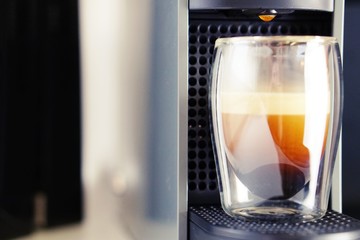 Coffee time in office. Capsule espresso in double glass cup - 100% arabica