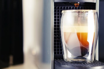 Coffee time in office. Capsule espresso in double glass cup - 100% arabica