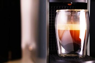 Coffee time in office. Capsule espresso in double glass cup - 100% arabica