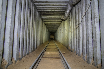 Underground square tunnel with rails for minecart. 