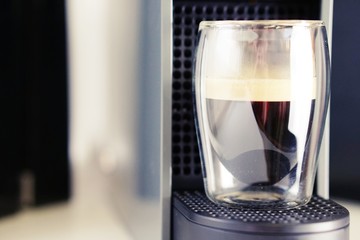 Coffee time in office. Capsule espresso in double glass cup - 100% arabica