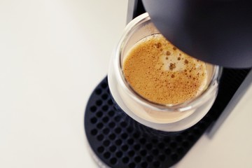 Coffee time in office. Capsule espresso in double glass cup - 100% arabica