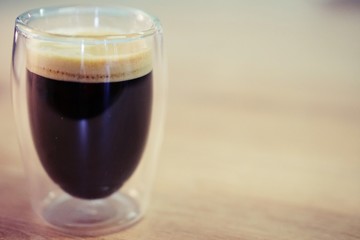 Coffee time in office. Capsule espresso in double glass cup - 100% arabica