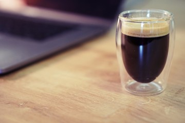 Coffee time in office. Capsule espresso in double glass cup - 100% arabica