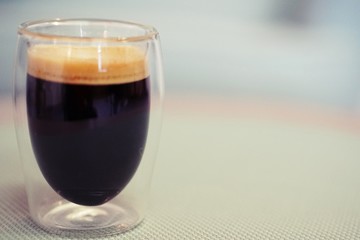 Coffee time in office. Capsule espresso in double glass cup - 100% arabica