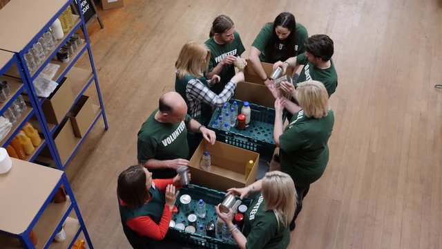 Food Bank volunteers help to sort food for hungry people and with social issues. Aerial View. Looking down from above,