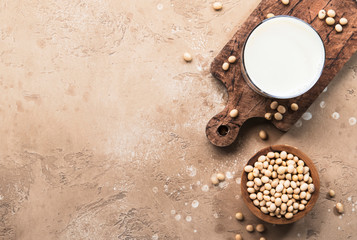 Soy milk and soy bean on beige background. Alternative Non-dairy milk concept. Vegan Beverage. Copy...