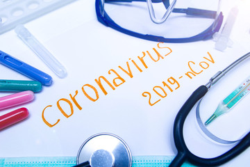 Coronavirus diagnostic and treatment analysis concept. Laboratory table with a respiratory mask, a...