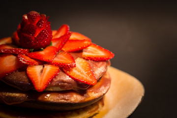 strawberry chocolate pancake with black background