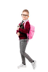 Back to school. Beautiful little girl dressed like a School girl - in white shirt, red blouse and gray pants, glasses hold a book, school bag and posing like model. Isolated on white.