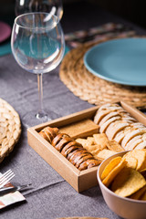 Different bread toast slices on a wooden box on a prepared and served food table on a restaurant